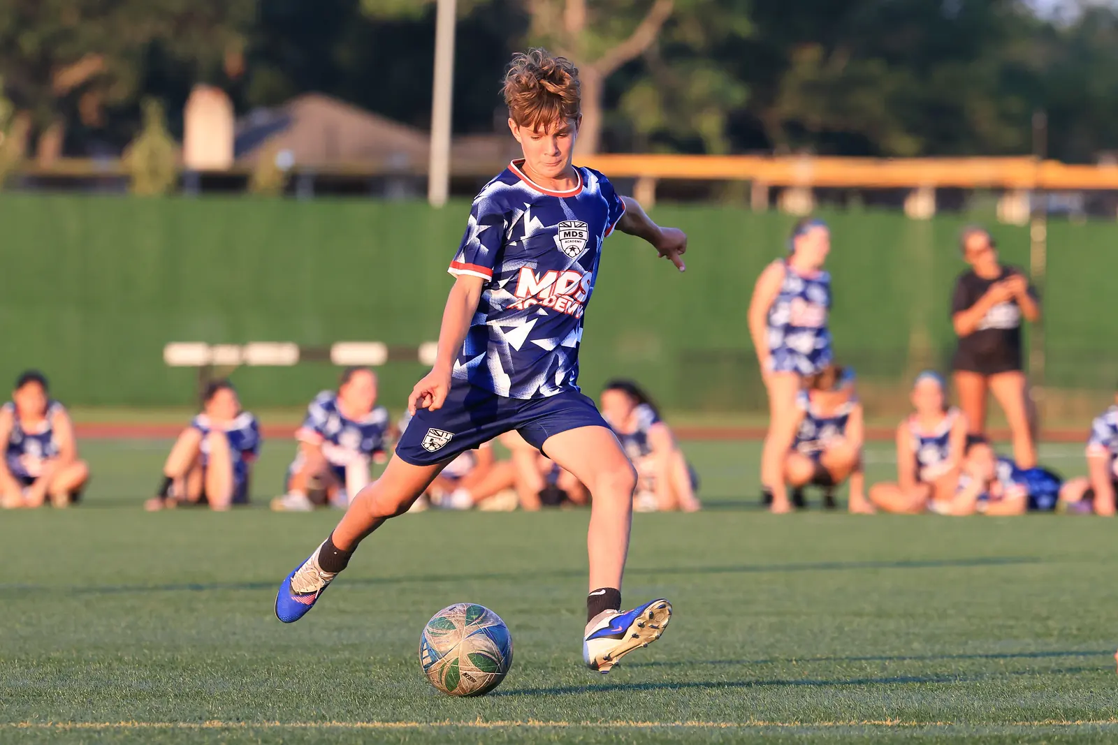 Player striking the ball at an MDS Academy camp, powered by MDS Academy