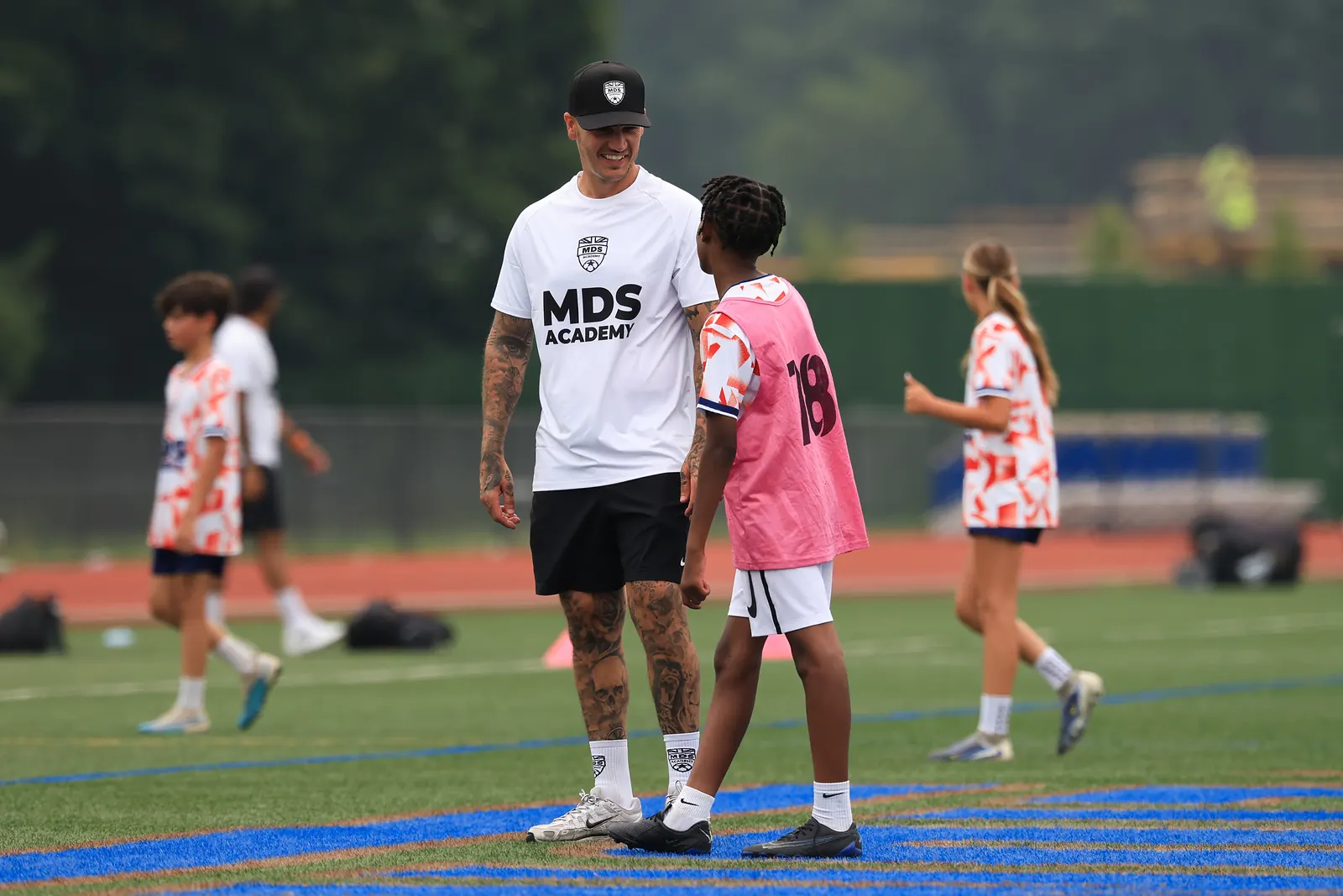 MDS Academy coach talking with a player during a training session in New Jersey